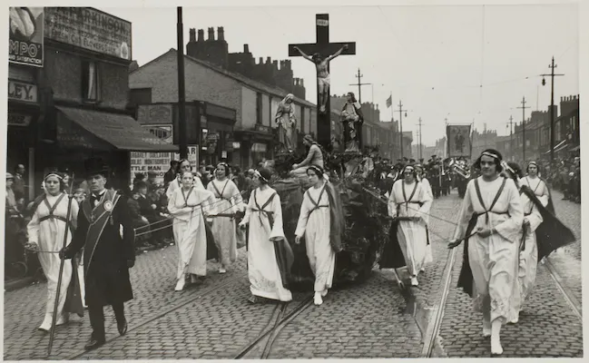 Vintage black-and-white photograph of a St Walburge's religious street procession featuring a large crucifix float.
