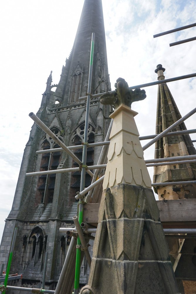 Scaffolding around St Walburge's spire, with a newly restored pale stone pinnacle in the foreground.