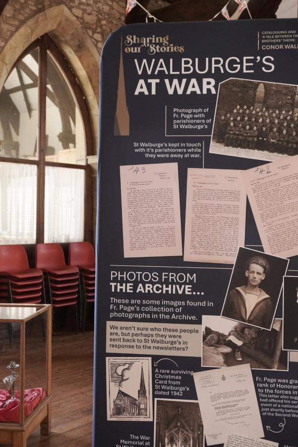 "Walburge's at War" exhibition banner with wartime letters, a group photograph of uniformed men and archive photographs.